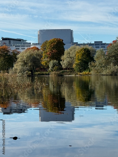 Autumn white building and tree Reflected in a Calm water