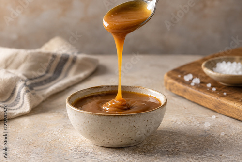 Golden caramel dripping from a spoon