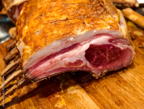 Roasted rack of prime rib beef on wooden board