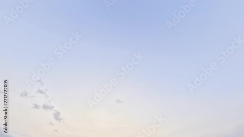 Background of clear blue twilight sky with soft golden sunset gradient and flying bird. Scenic atmospheric evening sky nature backdrop template with large copy space for web banner, poster.