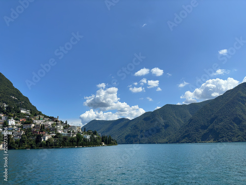 Lake Lugano with mountains and blue sky, Switzerland