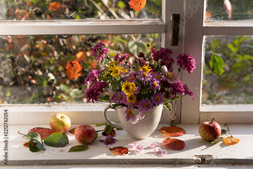 A bouquet of autumn asters on the windowsill
