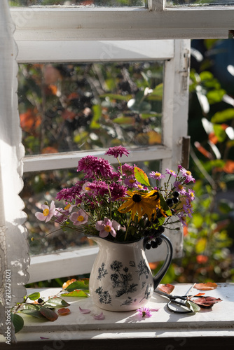 A bouquet of autumn flowers on the windowsill