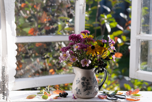 A bouquet of autumn flowers on the windowsill