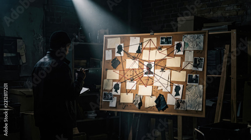 Detective examining a large conspiracy evidence board with connected photos and red strings in a dark room