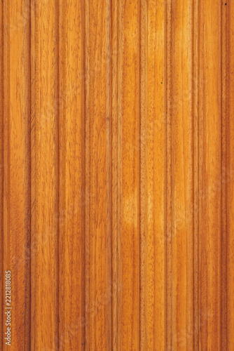 Fotografie Vertical wooden wall paneling with natural grain texture, warm orange tones and