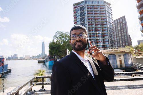 Young businessman making phone call in London city