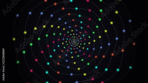 Hypnotic spiral of colorful dots moving inwards on dark background abstract motion footage.