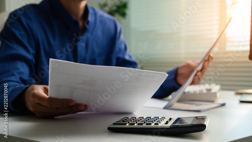 invoice, accounting, finance, payment, billing, calculator,paperwork, financial,Business professional reviewing an invoice and using a calculator for payment, billing, budget and financial accounting