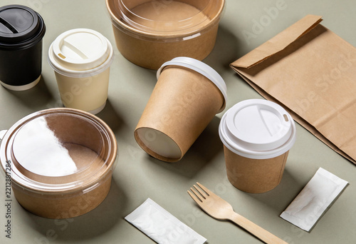 Eco friendly takeaway food containers and paper coffee cups are arranged for branding