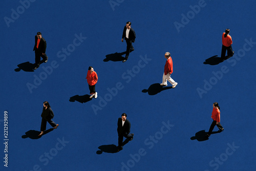 People Walking Across Minimal Deep Blue Space