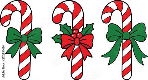 Set of three decorative christmas candy canes with green bows and holly berries