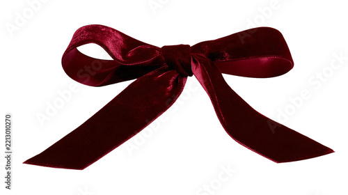 Isolated luxurious red velvet gift bow. Elegantly tied ribbon perfect for celebrations and decoration.