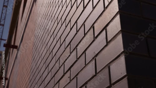 Close up of brick wall corner with sunlight and shadow