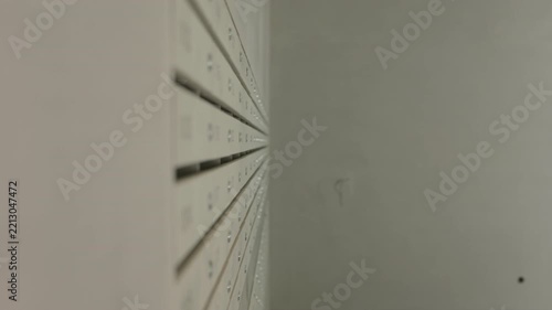 Numbered metal mailboxes installed in modern apartment building