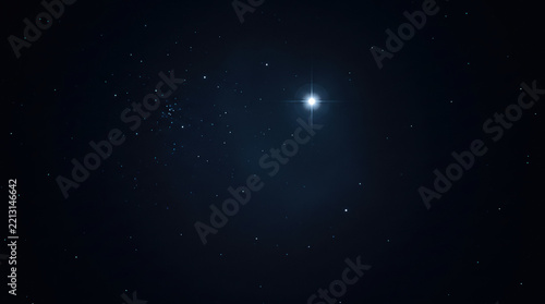 Bright Glowing Star Shining in the Dark Night Sky With Space Galaxy Background