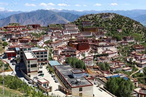 Panorama of Ganden Monastery in Dagze, Tibet, rebuilt after the Cultural Revolution, with traditional Tibetan buildings covering a mountain hillside, July 2025