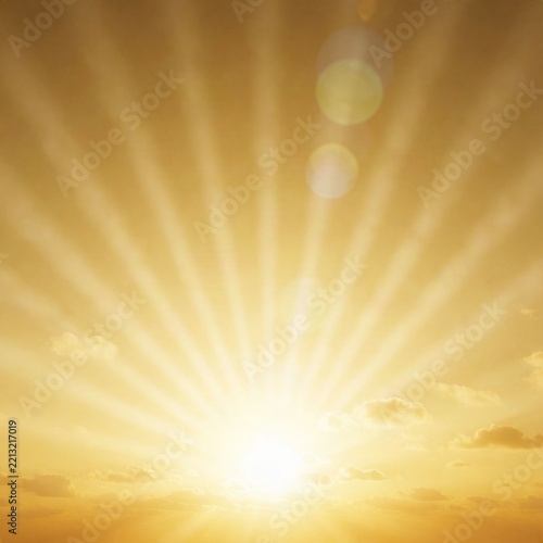 Golden sun rays radiating through a warm sunset sky with soft clouds