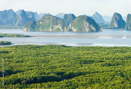 Coastal View of Phang Nga Bay from Samet Nang Chi Viewpoint, Thailand. Elevated view of limestone karst islands, calm coastal water, and vast mangrove forest at Samet Nang Chi in Phang Nga, Thailand.