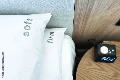Firm and soft pillow alternatives placed on bed for hotel room guests to choose in accordance to preference for a comfortable sleep