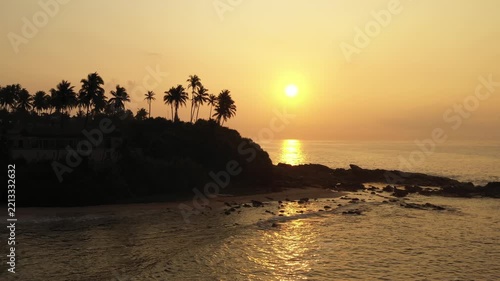 Sunrise over Silent Beach in Tangalle Sri Lanka with Palm Silhouettes