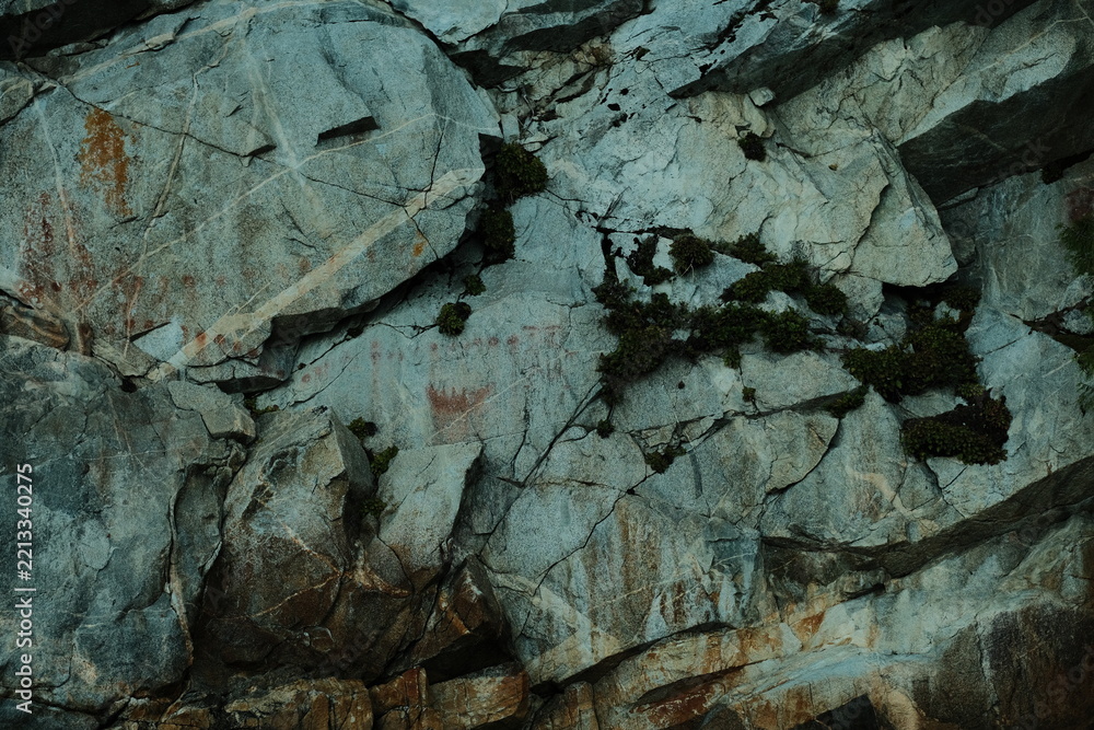 Fototapeta premium Fractured gray rock face texture close-up