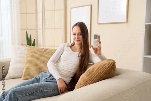 Home climate control and energy efficiency, young woman holding air condition...