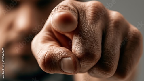 You Are The One: A close-up shot of a man's hand pointing directly at the viewer, conveying a sense of urgency, accusation, or direct address.