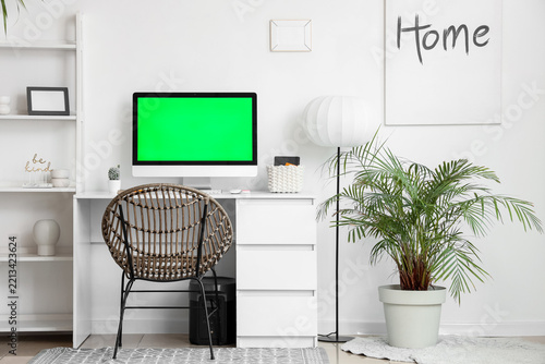 Remote work and home office setup, computer with green screen for mockup in m...