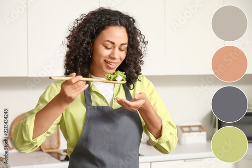 Healthy eating and nutrition, woman tasting fresh salad in home kitchen with ...