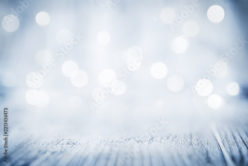 Christmas bokeh light texture on blue wooden desk background