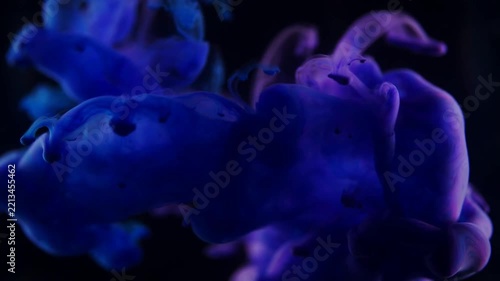 Deep blue ink blooming in water dark abstract background
