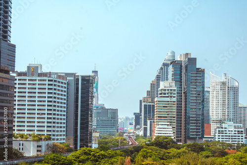Tourist photographing modern Bangkok city skyline from above