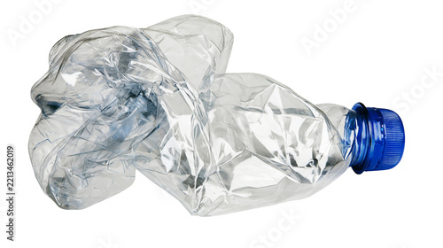 Isolated discarded crumpled clear plastic water bottle with blue cap, recycle and reuse concept.