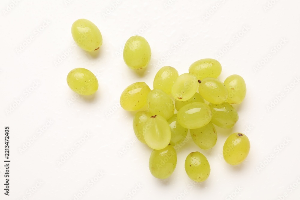 Fototapeta premium Fresh ripe grapes on white background, flat lay
