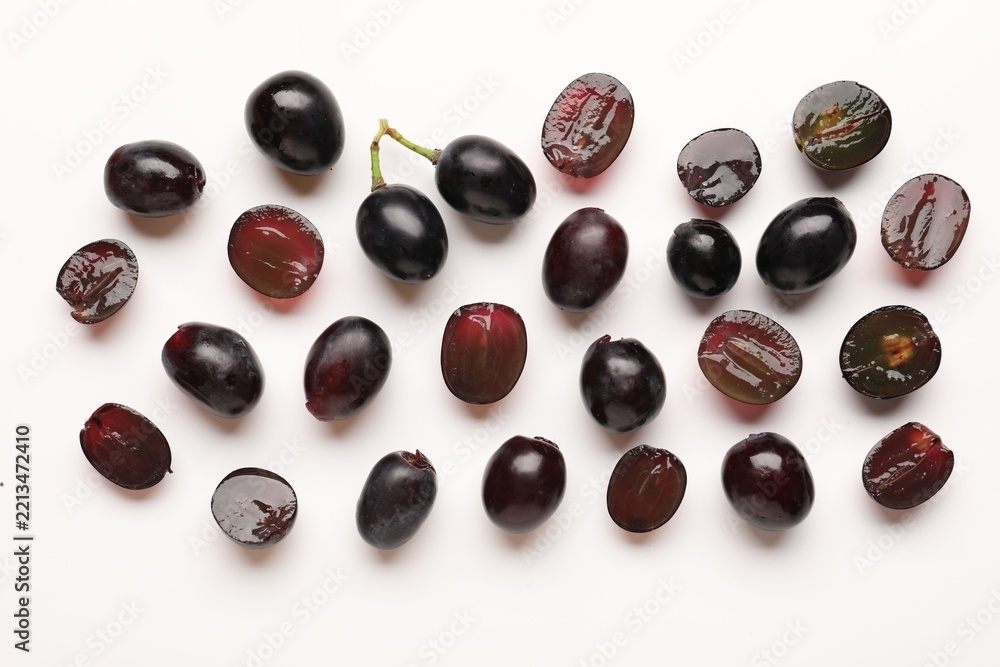 Fototapeta premium Fresh ripe grapes on white background, flat lay