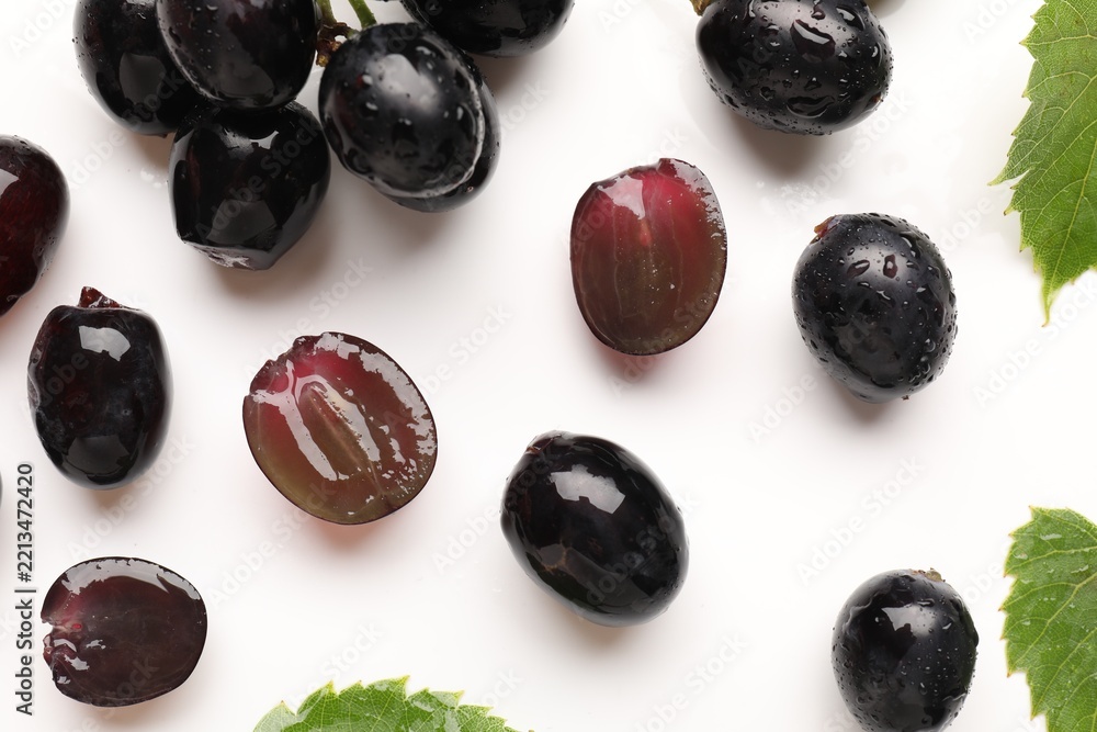 Fototapeta premium Fresh ripe grapes on white background, flat lay