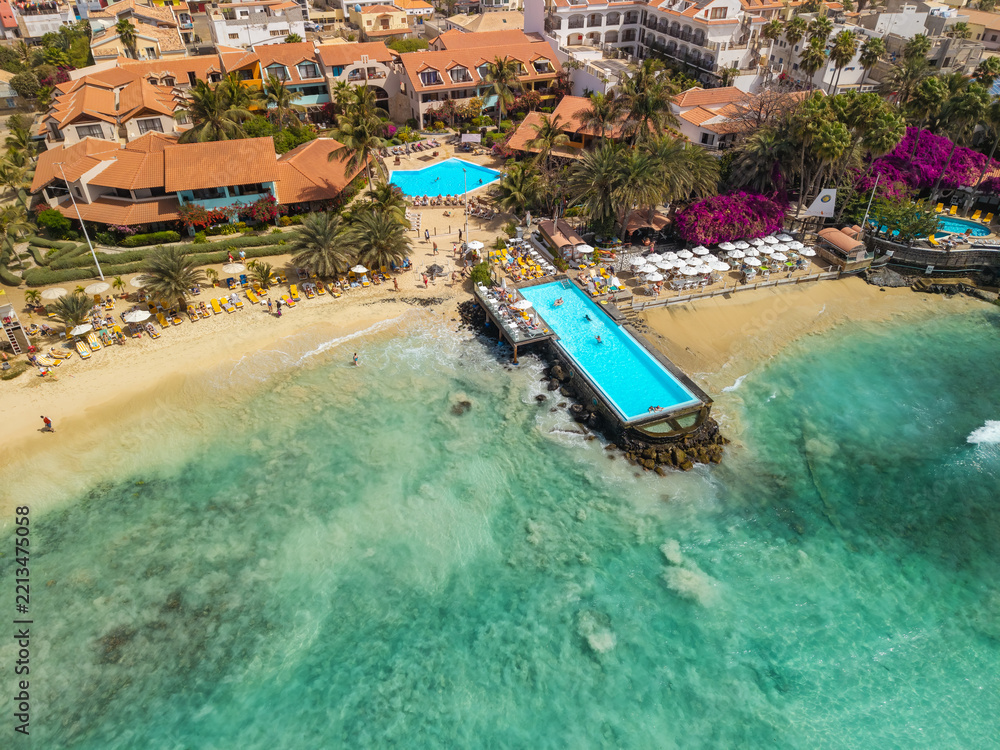 Fototapeta premium Aerial view of beachfront resort and pool at Santa Maria beach in Sal Cape Verde