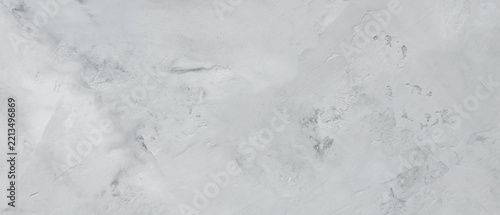 Fotografie Pale gray concrete surface with uneven trowel strokes and scuffed patches formin