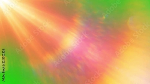 Bright golden light rays shimmering against a vibrant green background with soft lens flare effects