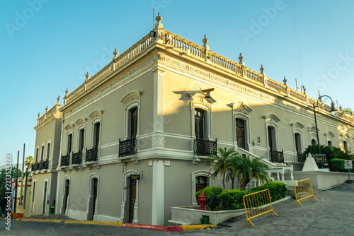 Historic Santiago Apostol church with twin bell towers and colonial architecture under a clear blue sky in Santiago, Nuevo Leon, Mexico.