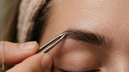 Close-up of Tweezers Shaping Eyebrows