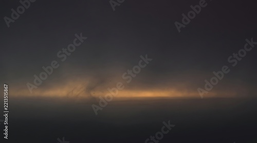 Eerie dark landscape with a glowing horizon line across a foggy field under a gloomy night sky landscape dramatic environment atmosphere mysterious halloween