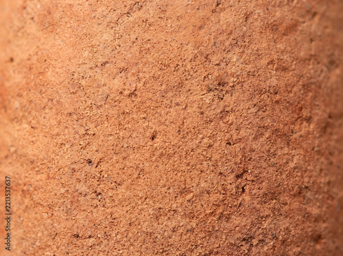 Macro close-up of rough porous terracotta clay pot surface texture