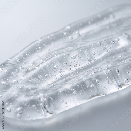 Macro close-up of clear cosmetic gel smear with tiny air bubbles
