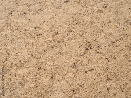 Macro texture of brown pressed cardboard or particle board surface