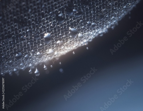 Water Droplets Passing Through Fine Mesh Filter