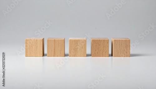 Five blank wooden cubes arranged horizontally on light gray