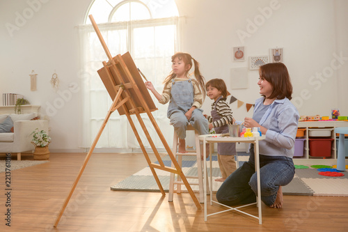 Asian Mother Teaching Children Painting and Creative Art at Home