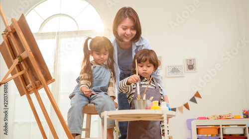 Asian Mother Teaching Children Painting and Creative Art at Home